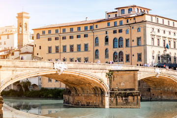 Naklejka na ściany i meble Cityscape view on the Holy Trinity bridge and old palace on Arno river in Florence