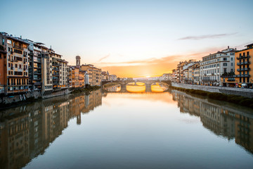 Fototapeta na wymiar Cityscape view on Arno river with famous Holy Trinity bridge on the sunset in Florence