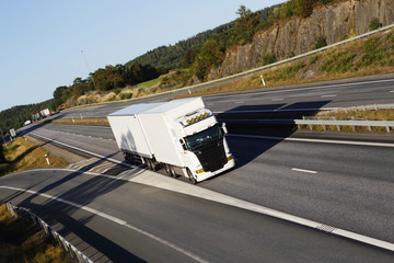 Naklejka premium large white truck driving on highway, elevated view