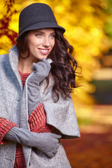 Fashion woman on a background of red and yellow autumn leaves