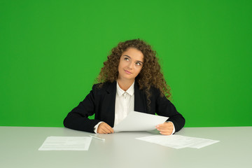 The young girl work with document on the green background