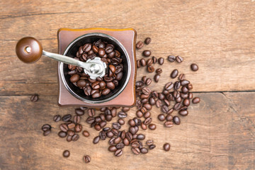 Top view of old Vintage coffee grinder in a wooden case with roasted coffee beans on wooden table background. (for Drip Coffee)