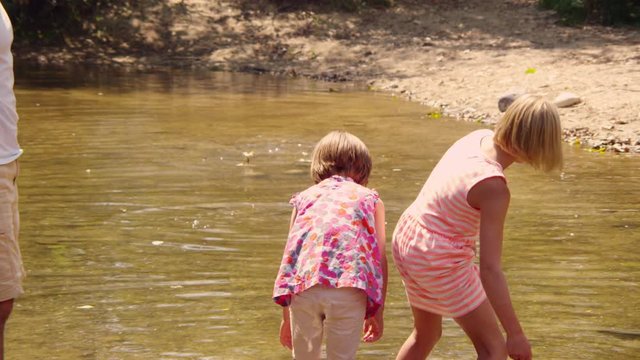 Mom and son looking at fish in the stream