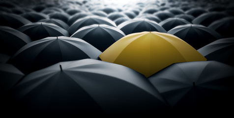 Yellow umbrella in the middle of a sea of black umbrellas, representing special element, a different view in the society. - obrazy, fototapety, plakaty