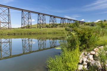 Railroad High Bridge / A long and tall railroad bridge reflecting in a river.