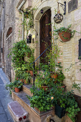 Fototapeta na wymiar Glimpse of a picturesque street in Assisi, ancient Italian medieval town