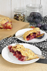Slice of fresh baked homemade strudel with plum, walnuts and sug