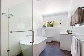 Naklejka na ściany i meble Stylish clean bathroom with shower and bath tub
