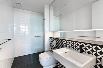 Stylish clean bathroom with shower and bath tub
