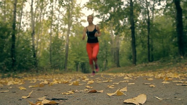 A woman is turning on the music in her phone and beginning her morning run.