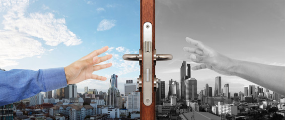 Hands trying reaching to grabbing open the door to another side, with contrast different place, life concepts