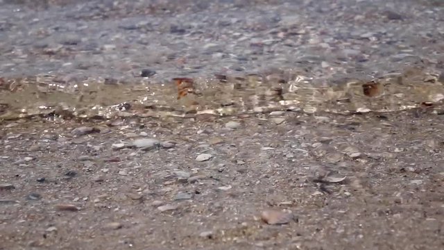 Sea waves breaking on the rocks. Close up. Slow motion