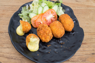 Egg fried cheese wrapped in black.