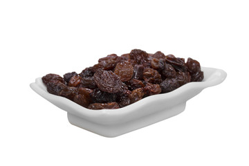 raisins in saucer on white background.