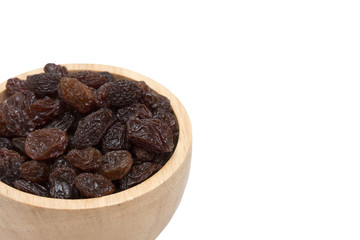 raisins in woodenbowl on white background.