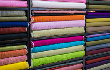 Fototapeta premium Roll in a colorful satin fabric store.