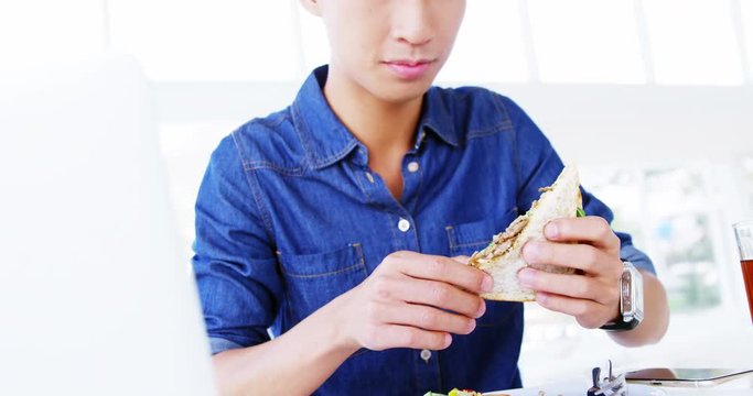 man eating sandwich with hands 