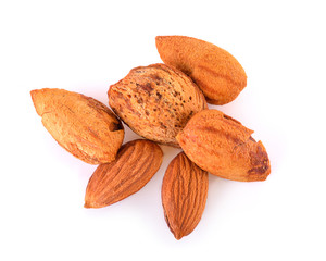 Heap of almond nuts isolated on white background
