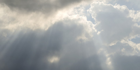 Fototapeta premium Rays make their way through the clouds. Picturesque clouds in the sky at sunset 