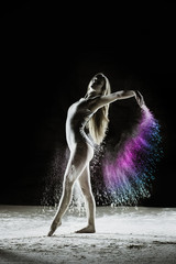 Wings - Young dancer traces patterns through a cloud of powder as she dances against a dark background