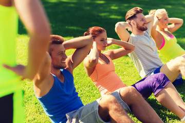 group of friends or sportsmen exercising outdoors