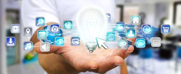 Businessman holding lightbulb with digital icons