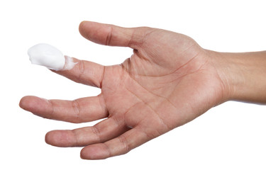 Moisturizing cream at the tip of a female finger isolated on white background.