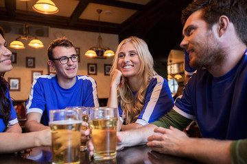 football fans or friends with beer at sport bar