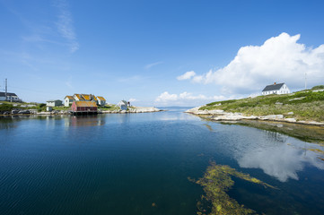 Fototapeta na wymiar Scenic landscape view of the calm waters of the harbour in the fishing village of Peggy's Cove, in Halifax, Nova Scotia, Canada
