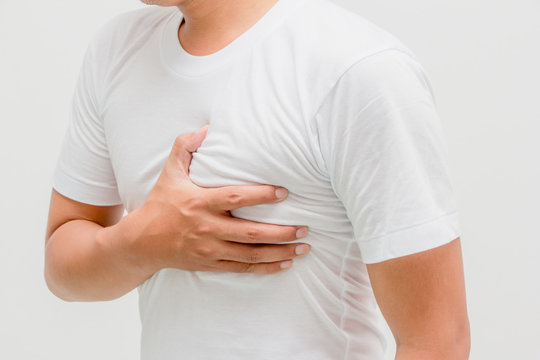 Man Having Heart Ache, Holding Hand On Her Chest. Heart Attack Or Stroke. Health Care Concept.