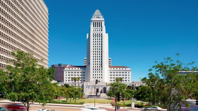 Time-lapse of Los Angeles City Hall with a fountain in Grand Park in the foreground