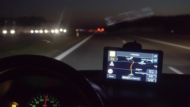 A man driving a car on the overpass turning. Inside view. Evening-night time, real time capture. Wide angle