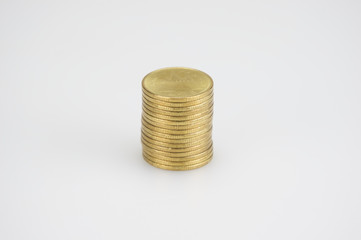 Close up pile of gold coins isolated on white background