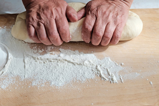 Making dough by female hands at kitchen