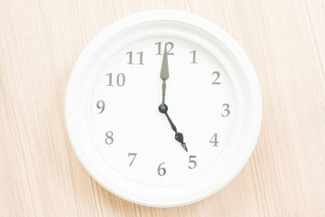 White clock on wood wall