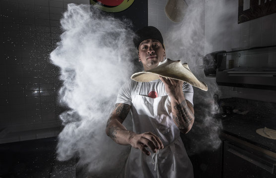 Professional Pizzero working in the Restaurant