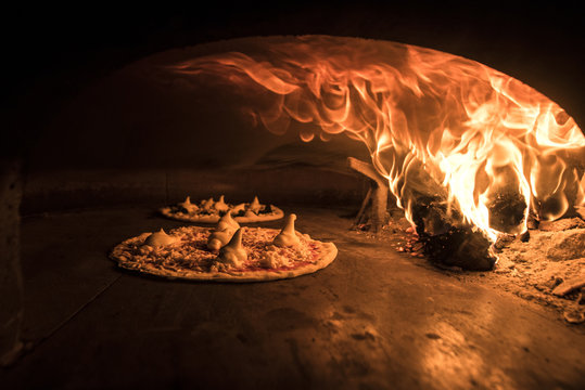 Pizza being baked in the wood oven