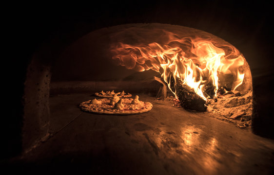 Pizza being baked in the wood oven