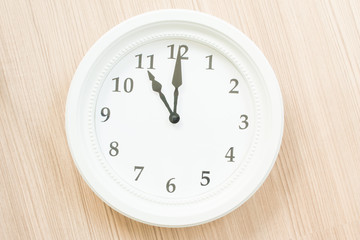 White clock on wood wall