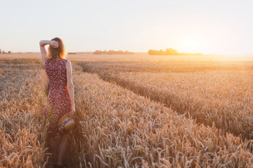 inspiration or waiting concept, happy beautiful young woman in sunset field, dream