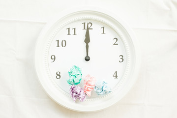 Clock and colorful crumpled paper