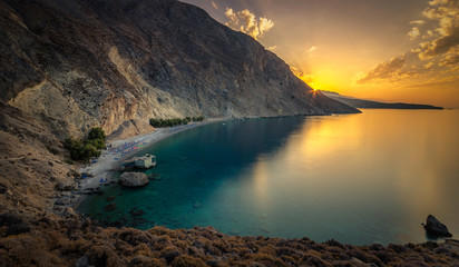 Glyka Nera beach (Sweet Water or Fresh Water). View of the remote and famous Sweet Water Beach in south Crete, with its unique tavern on the rock inside sea. This is a nudist beach.

