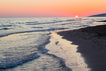 Beautiful blue waves of adriatic sea during sunset