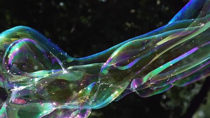 Multi-colored big bubble blower. Bubble wand. Soap bubbles show.