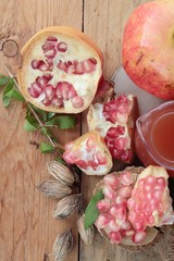 Ripe pomegranates with juice on wood background.