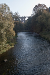 Weisse Elster river with Elstertalbrucke brick railway bridge near Plauen city in Saxony