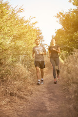 Fototapeta premium Comfortable couple running down a path