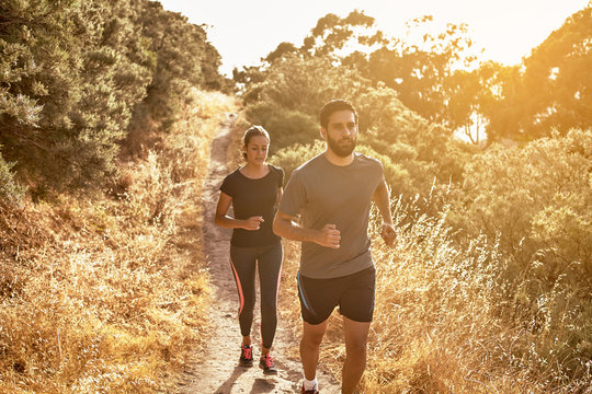 Pretty Girl Running Behind Bearded Guy