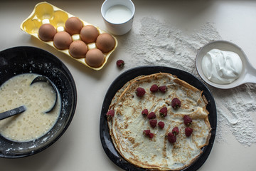 Cooking of pancakes, with sour cream and berry