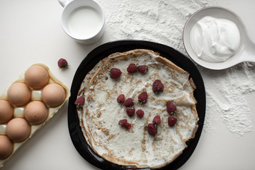 Cooking of pancakes, with sour cream and berry